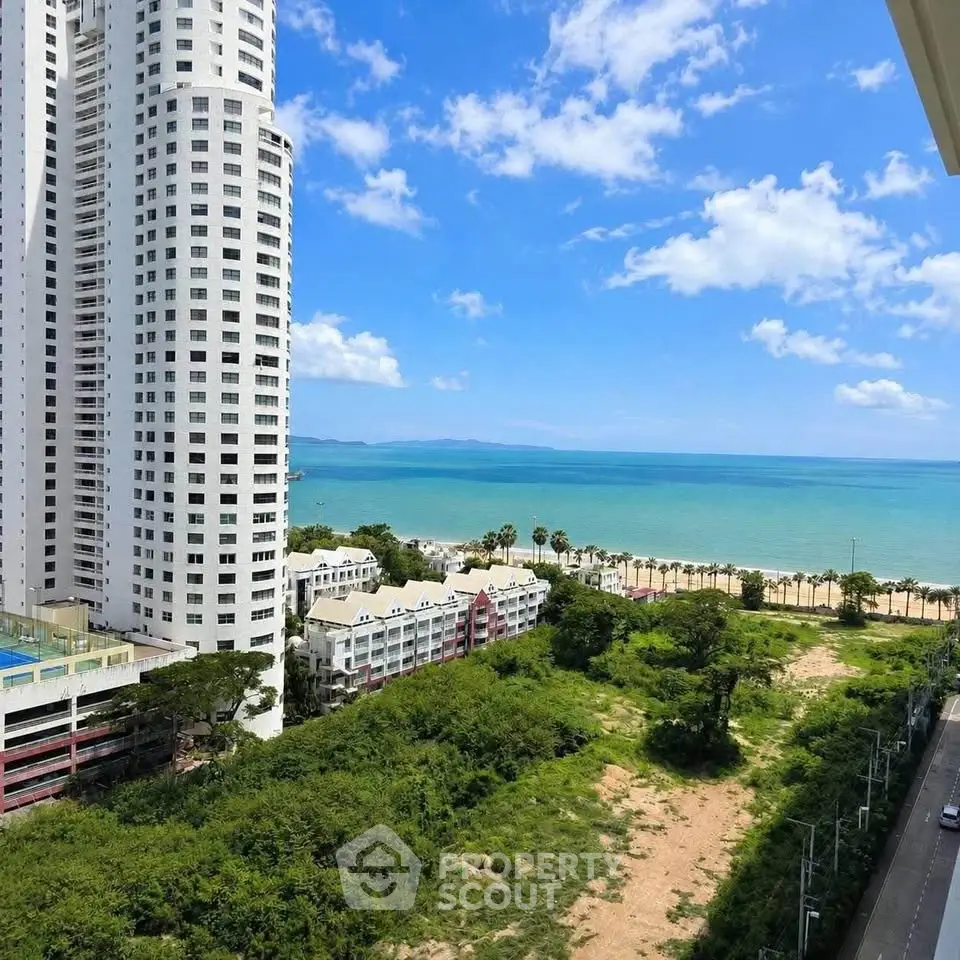 Stunning ocean view from high-rise building with lush greenery and clear blue skies.