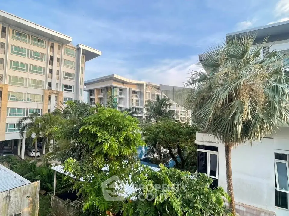 Stunning view of modern apartment buildings surrounded by lush greenery and palm trees.