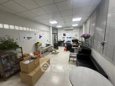 Spacious office room with modern furniture and ample natural light, ideal for productive work environment.