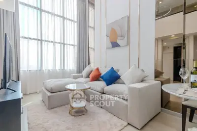 Luxurious living room with modern decor and large windows in a stylish apartment.