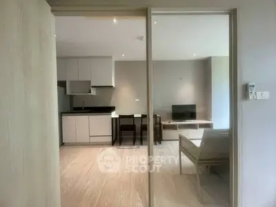 Modern open-plan living room with sleek kitchen and stylish decor