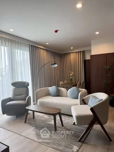 Modern living room with stylish furniture and natural light, perfect for relaxation and entertaining.
