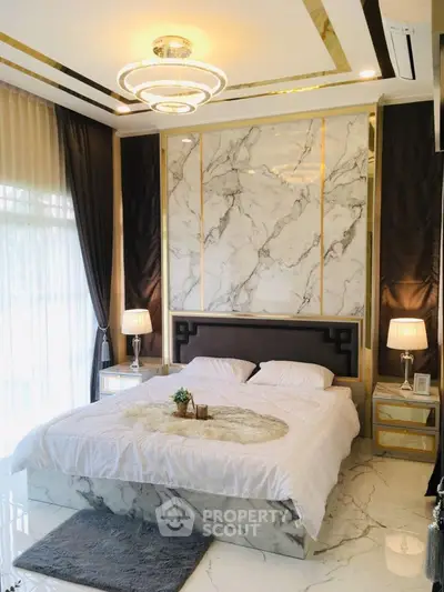 Luxurious bedroom with marble accents and elegant lighting