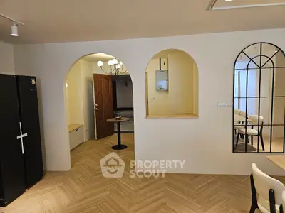 Stylish interior with arched doorways and modern decor in a cozy living space.