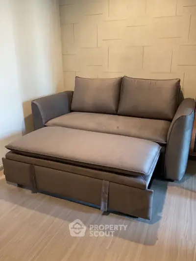 Modern living room with stylish sofa bed and elegant wall design