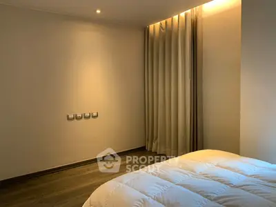 Cozy bedroom with soft lighting and elegant curtains, perfect for relaxation.