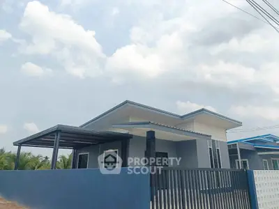 Modern single-story house with sleek design and spacious outdoor area.