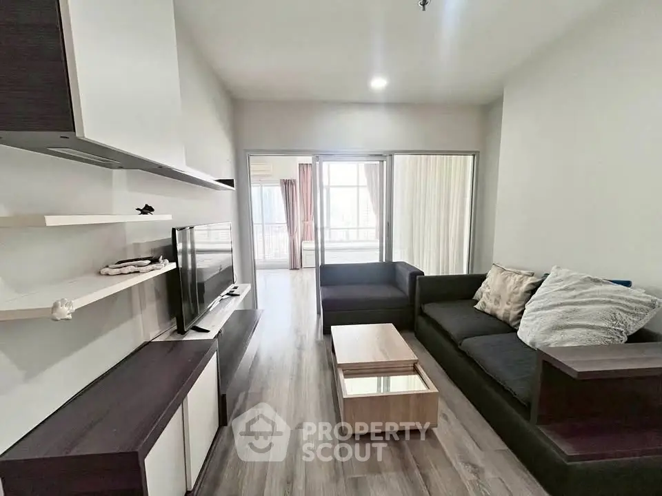 Modern living room with sleek furniture and natural light, perfect for relaxation and entertainment.
