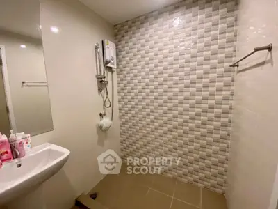 Modern bathroom with tiled wall and shower in sleek design