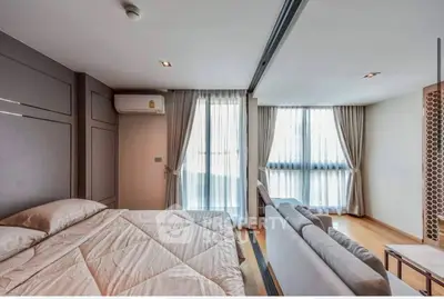 Spacious modern bedroom with large windows and elegant decor