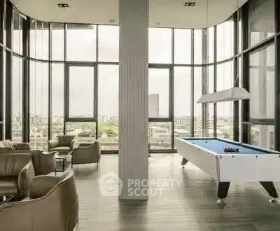 Luxurious high-rise building lounge with pool table and panoramic city views.