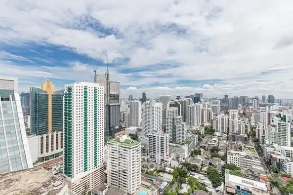 Stunning cityscape view of modern high-rise buildings under a vibrant blue sky.