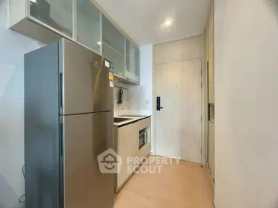 Modern compact kitchen with sleek appliances and minimalist design