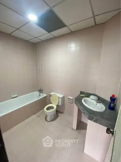 Spacious bathroom with bathtub and modern fixtures in a real estate property.