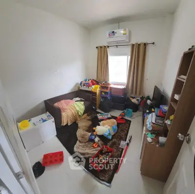 Cozy children's bedroom with toys and air conditioning, perfect for a playful and comfortable living space.