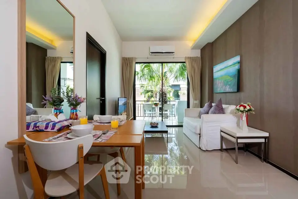 Modern living room with elegant decor and balcony view, featuring stylish furniture and natural light.
