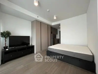 Modern studio apartment with sleek design and integrated storage solutions.
