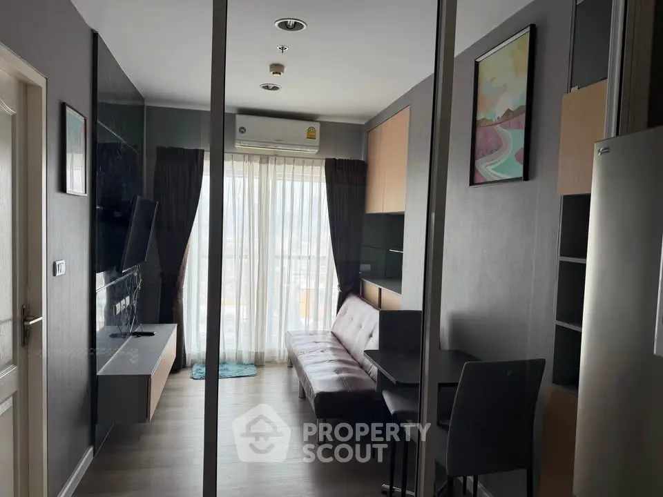 Modern living room with sleek furniture and large window view