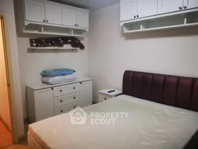 Cozy bedroom with built-in storage and elegant headboard, perfect for restful nights.