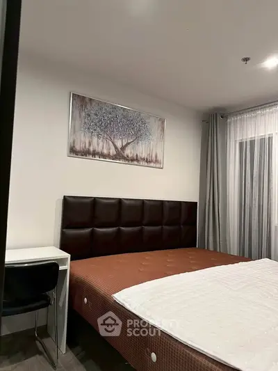 Modern bedroom with stylish decor and large window for natural light
