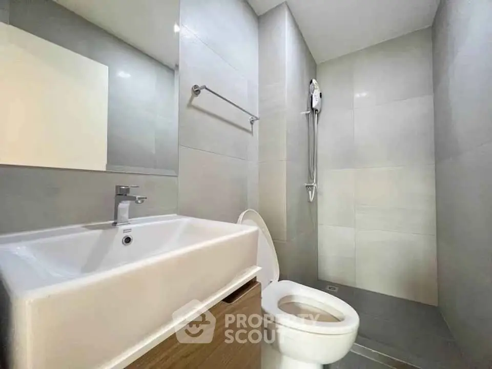 Modern bathroom with sleek fixtures and minimalist design in a contemporary apartment.