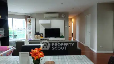 Spacious living room with modern decor and large windows offering natural light.