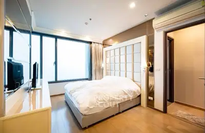Modern bedroom with large window and stylish decor
