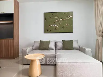 Modern living room with stylish gray sofa and elegant wall art