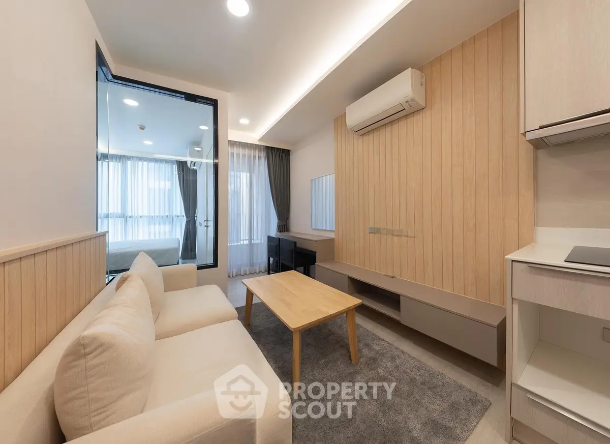 Modern living room with beige sofa, wooden accents, and air conditioning in a stylish apartment.