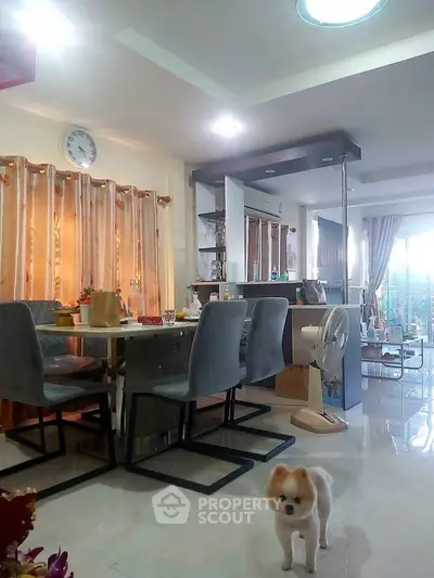 Spacious dining area with modern decor and natural light, featuring elegant furniture and a cozy atmosphere.
