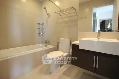 Modern bathroom with sleek fixtures and bathtub in a contemporary apartment.