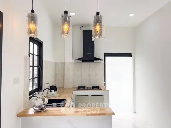 Modern kitchen with stylish lighting and wooden countertops