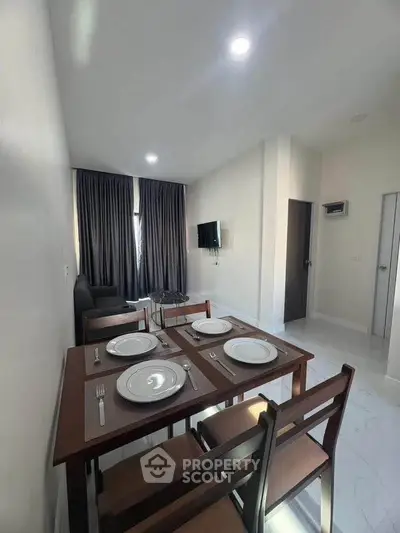Modern dining area with elegant table setting in a cozy apartment living room.