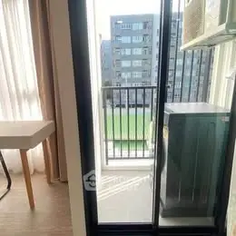 Modern apartment balcony with city view and air conditioning unit