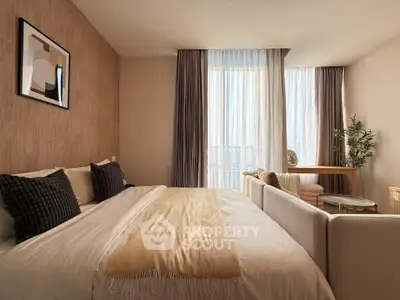 Luxurious bedroom with modern decor and large windows offering stunning city views.