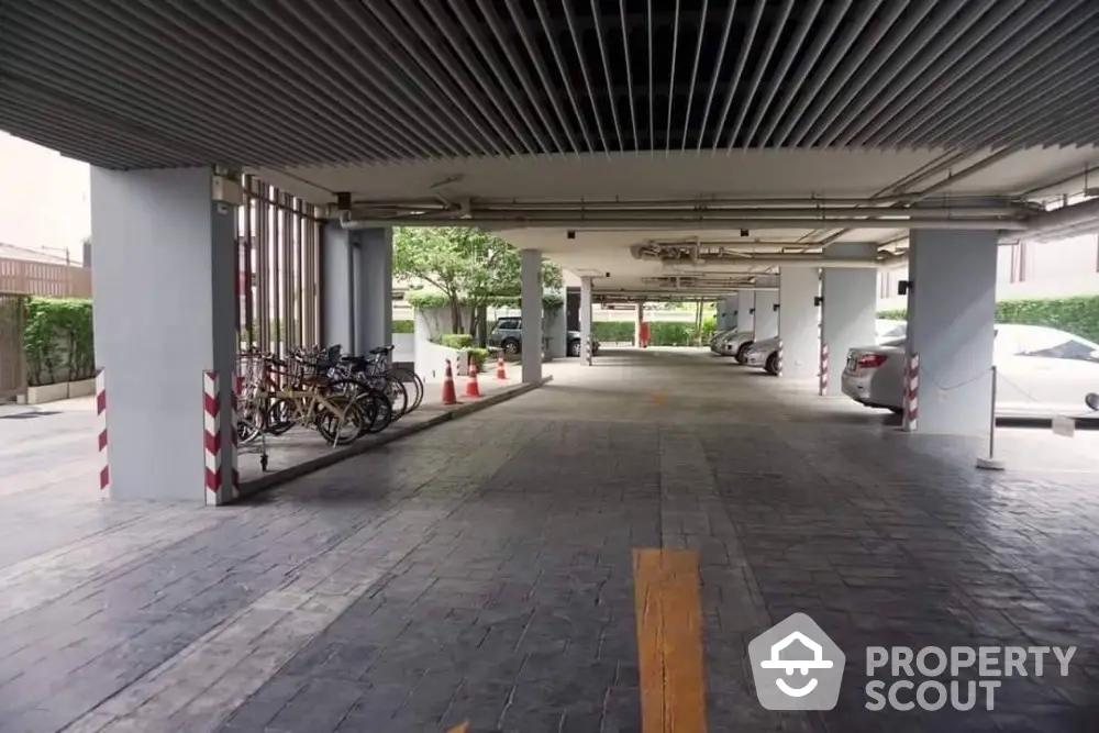 Spacious covered parking area with ample space and bicycle racks in modern building