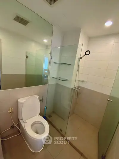 Modern bathroom with glass shower and sleek tile design