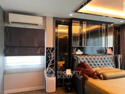 Luxurious bedroom with elegant decor and plush bedding in modern apartment.