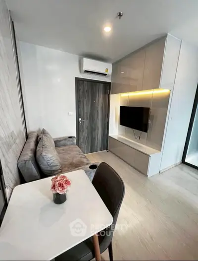 Modern living room with sleek furniture and wall-mounted TV