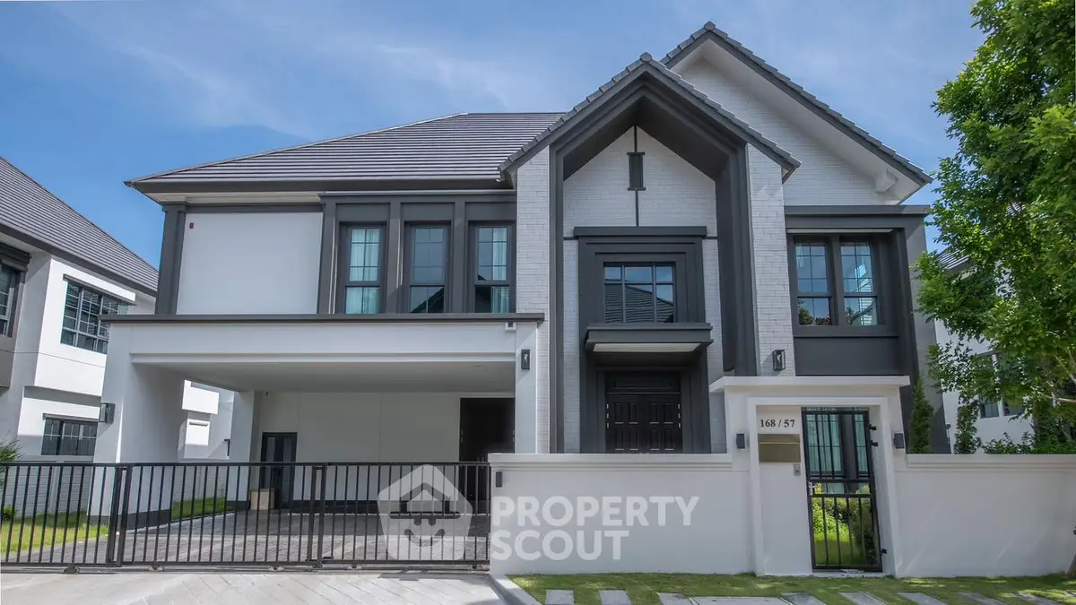 Elegant modern house with sleek design and spacious driveway in a serene neighborhood.