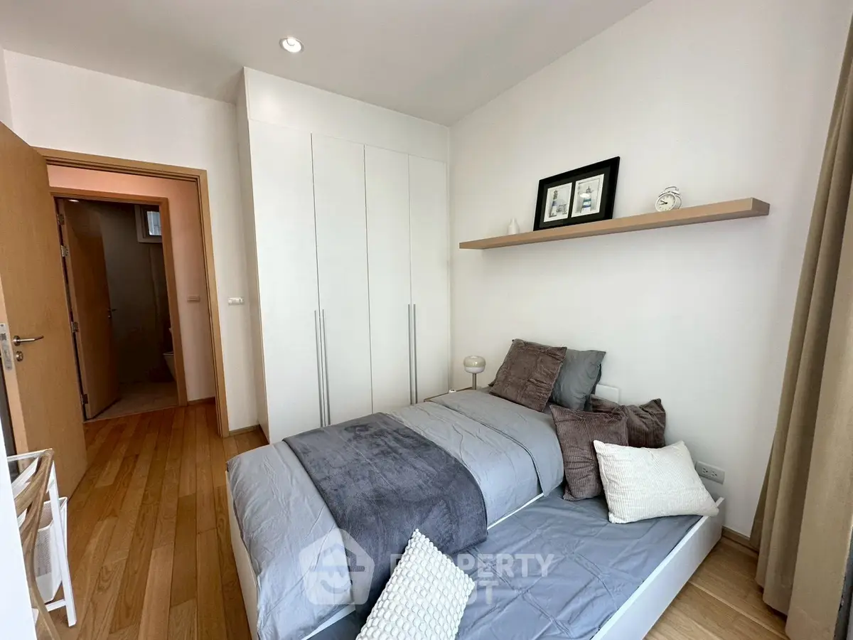 Cozy modern bedroom with wooden flooring and minimalist decor