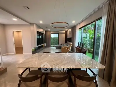 Spacious modern living room with garden view and elegant dining area