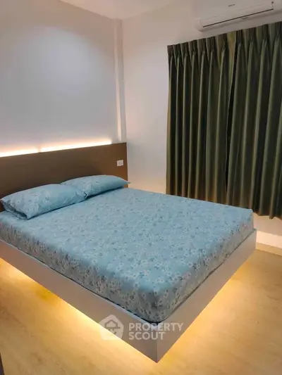 Modern bedroom with floating bed and ambient lighting