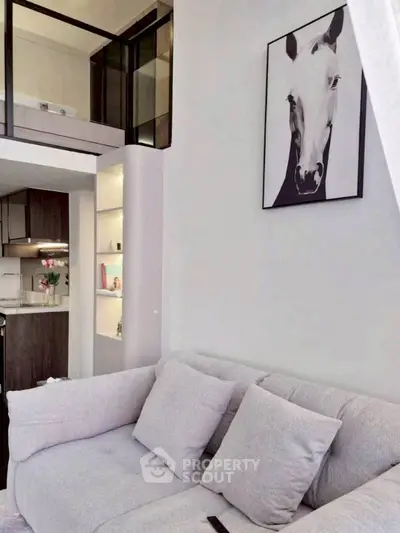 Modern living room with stylish decor and open kitchen layout in a chic apartment.