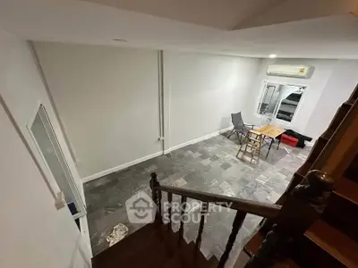 Spacious interior with modern flooring and cozy seating area, perfect for relaxation.
