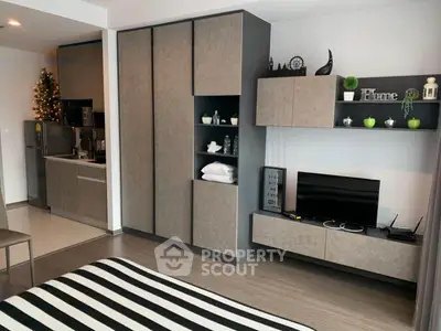 Modern studio apartment with sleek kitchen and stylish decor