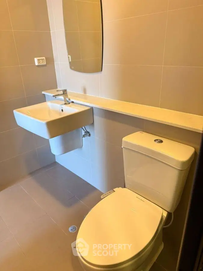 Modern bathroom with sleek fixtures and neutral tiles