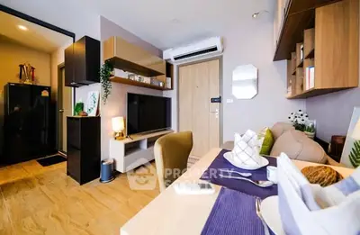 Modern living room with stylish decor and open layout, featuring a cozy dining area.