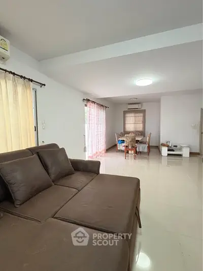 Spacious living room with modern furniture and large windows for natural light.