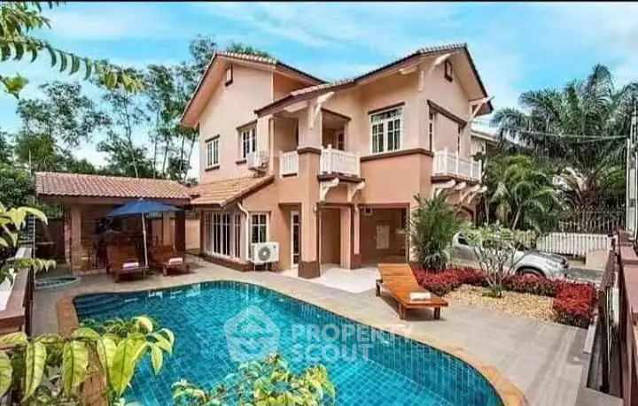Stunning two-story villa with private pool and lush garden in tropical setting.
